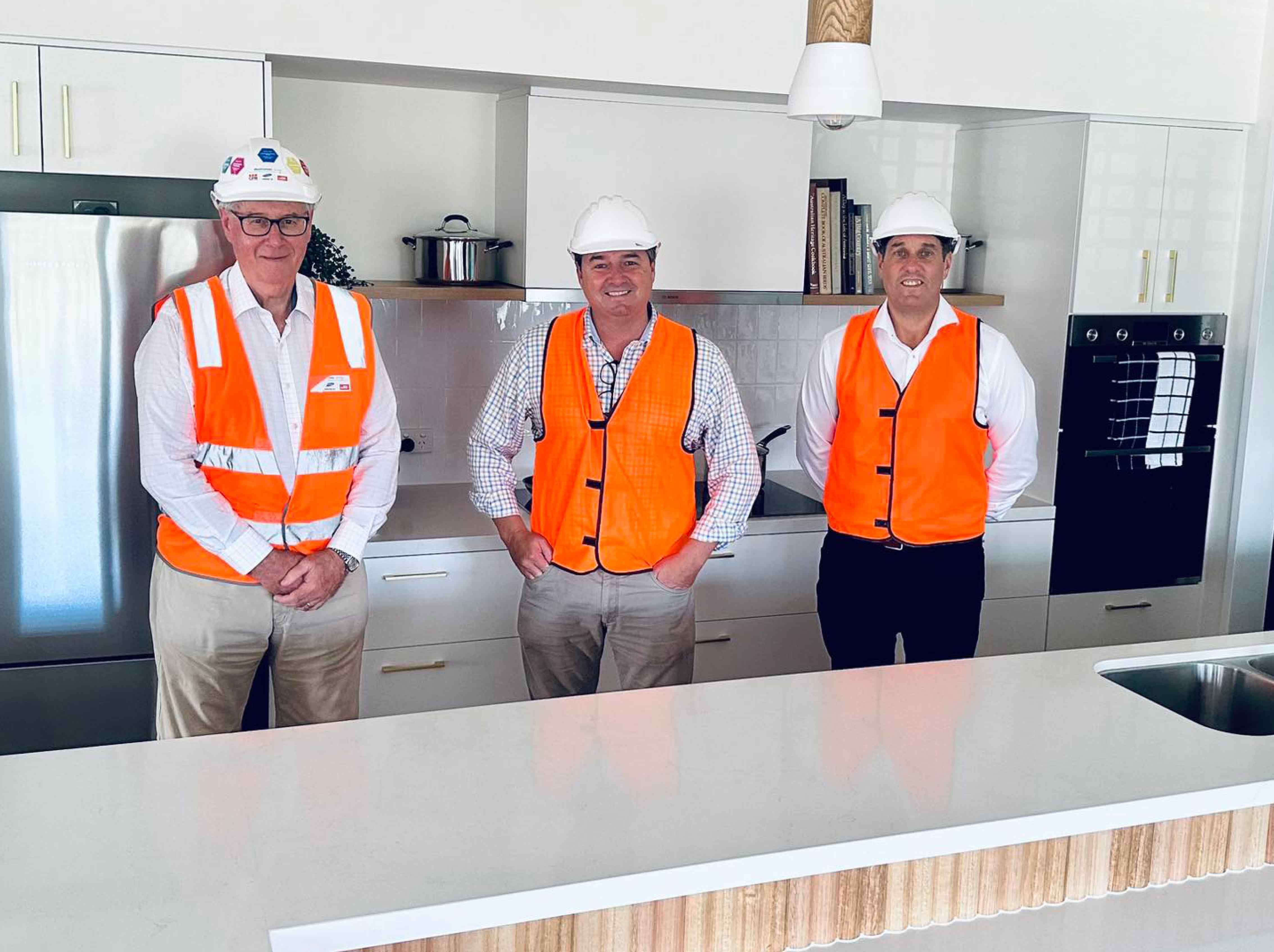 From left: Tony Leahy (CEO, St Agnes’ Catholic Parish), Pat Conaghan (Member for Cowper), Peter Orford (Project Manager, St Agnes’ Catholic Parish) inside the kitchen of a coastal home.