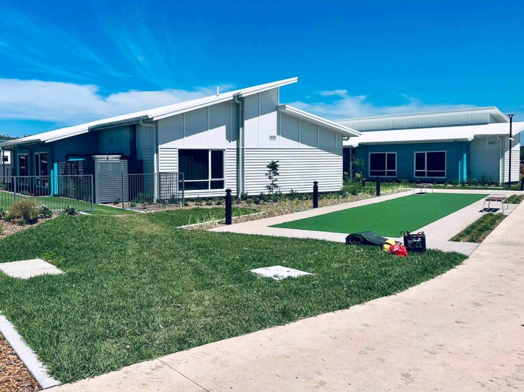 Exterior of the coastal homes and bocce court.