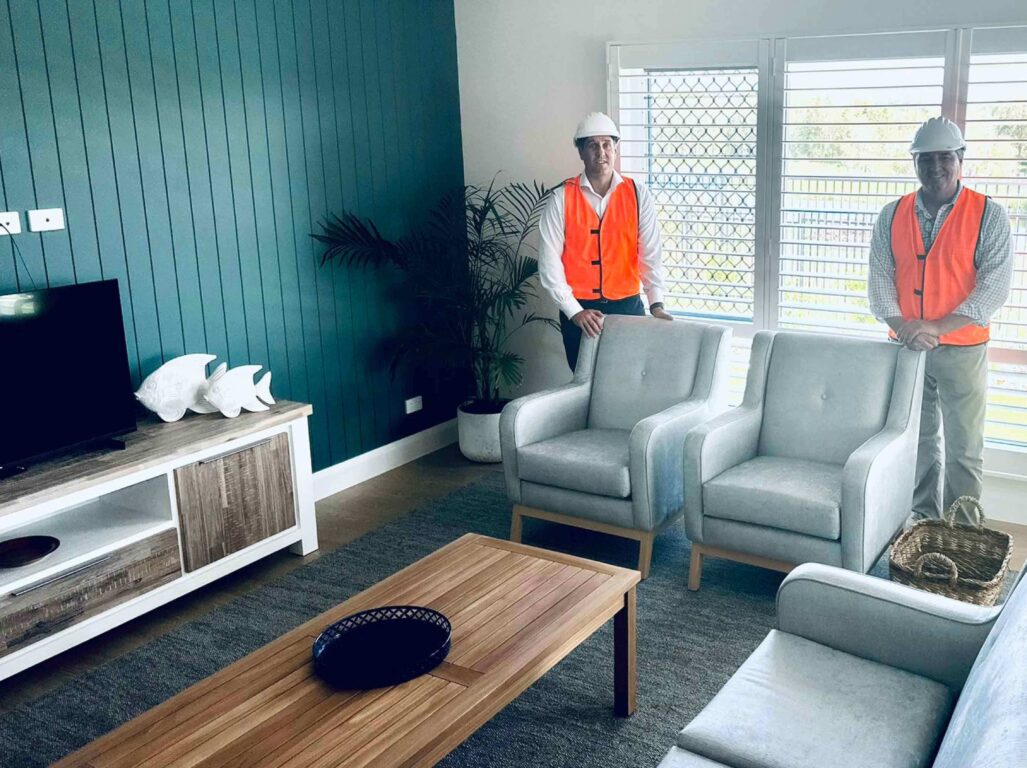 From left: Tony Leahy (CEO, St Agnes’ Catholic Parish) and Pat Conaghan (Member for Cowper) in the living room of a coastal home.